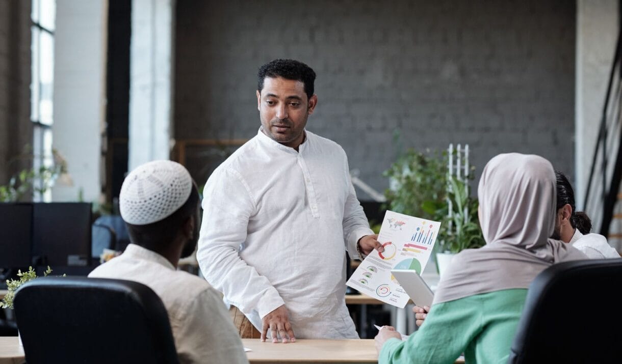 Confident Businessman With Financial Paper Looking ZWVQ27J 1220x715