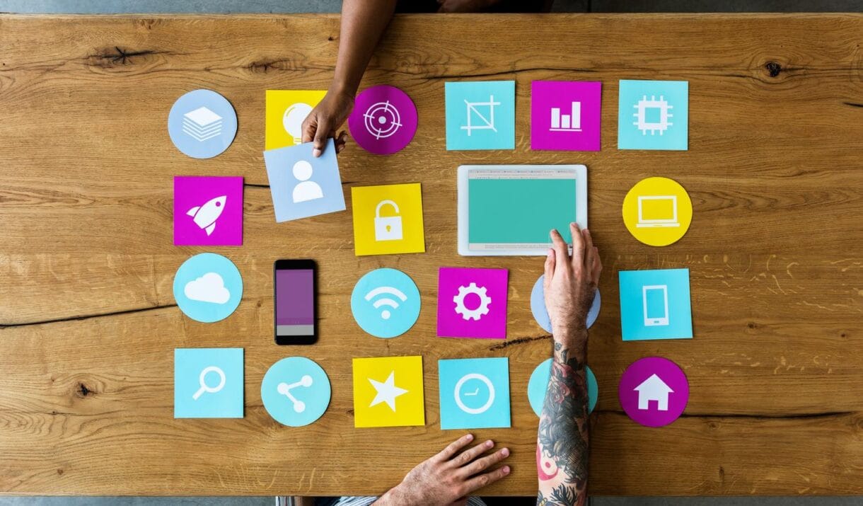 Group Of Computer Icon On The Wooden Table P77YUSB 1220x715