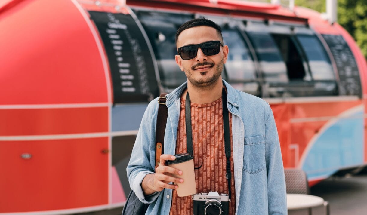 Young Male Photographer With Drink And Photocamera DHDDJAV 1220x715
