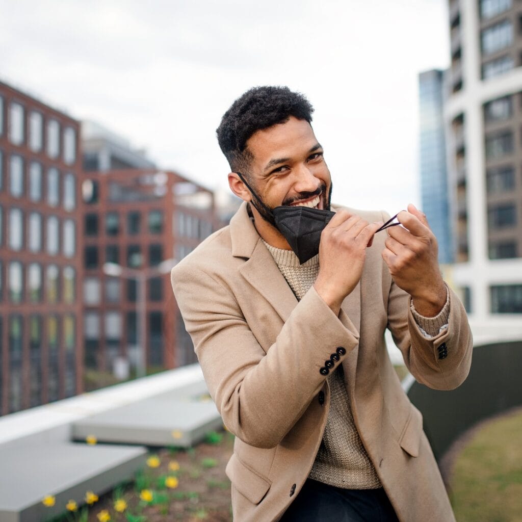 Cheerul Young Man Taking Off Face Mask On The Way ET72PLL 1024x1024