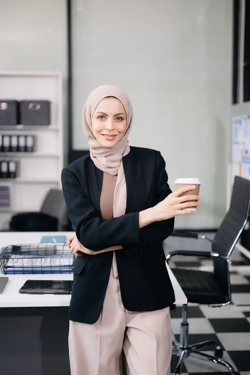 Female Entrepreneur Looking At The Camera While St FQVY956